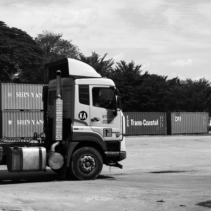 Monochrome photo of a transport truck at a shipping yard in Ipoh, Malaysia.